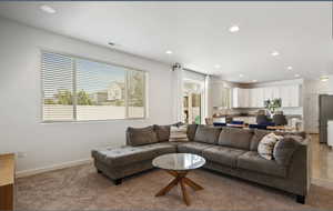 Living area with recessed lighting and carpet flooring