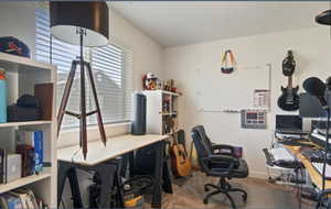 Office space with carpet flooring and baseboards