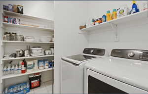 Laundry room featuring light tile patterned flooring and independent washer and dryer