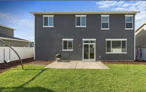 Back of house featuring a patio, a fenced backyard, and stucco siding
