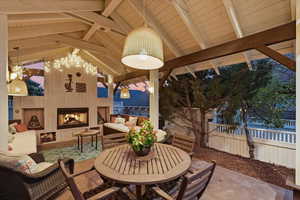 View of patio with an outdoor living space with a fireplace