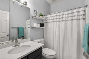 Full bath with vanity and curtained shower