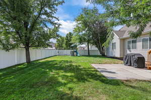 Fenced backyard featuring a playground
