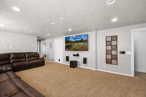 Cinema with carpet, a textured ceiling, and recessed lighting