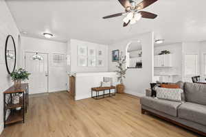 Living area featuring light wood-style floors and ceiling fan