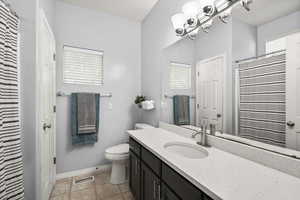 Full bath with vanity, light tile patterned flooring, and a shower with curtain
