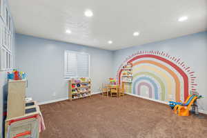 Playroom with carpet floors, recessed lighting, and a textured ceiling