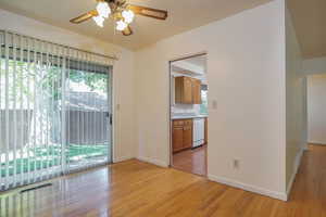 Spare room featuring light wood-style floors and a ceiling fan