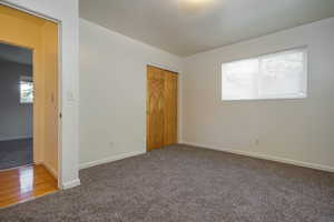 Unfurnished bedroom featuring carpet floors and a closet