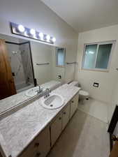 Full bath featuring vanity, a combined bath / shower with marble appearance, and light tile patterned flooring