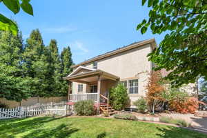 View of front of property with stucco siding and covered porch