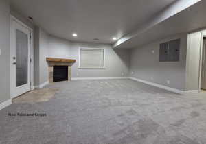 Downstairs living room featuring a tile gas fireplace