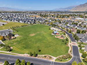 Aerial view of property and surrounding area with mountains and nearby suburban area