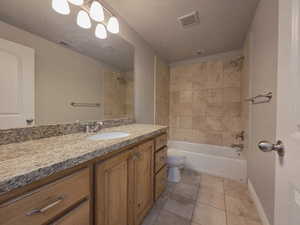 Bathroom with vanity, tile flooring, and tub / shower combination
