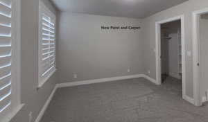 Bedroom with a spacious closet and windows for natural light