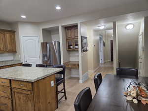 Kitchen featuring a granite countertop island and hardwood floors
