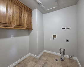 Washroom featuring washer hookup, electric dryer hookup, and tile flooring