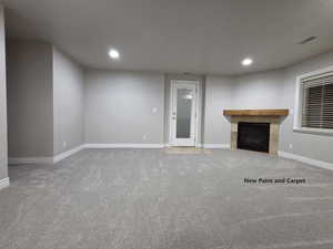 Downstairs living room featuring a tile fireplace