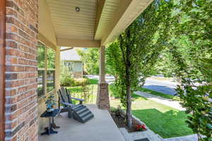 Porch featuring a lawn