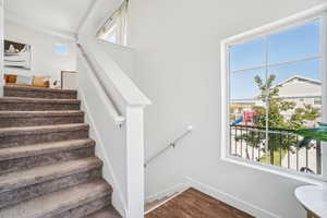 Stairs featuring wood finished floors and baseboards