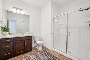 Bathroom featuring a stall shower and vanity