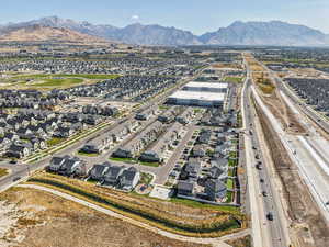 Aerial perspective of suburban area with a mountain backdrop and a highway