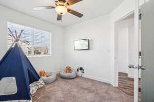 Rec room featuring carpet floors and a ceiling fan