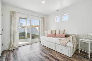 Bedroom featuring dark wood finished floors and access to outside