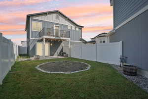 Back of house with a patio area, board and batten siding, and a fenced backyard