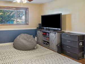 Recreation room featuring wood finished floors and ceiling fan