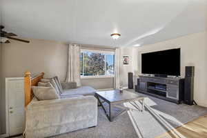Living area with wood finished floors and a ceiling fan