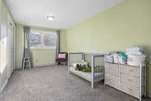 Bedroom featuring carpet flooring and baseboards