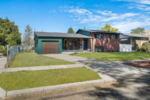 Tri-level home with brick siding, concrete driveway, and an attached garage