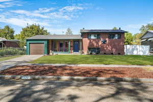 Split level home with brick siding, concrete driveway, and a garage