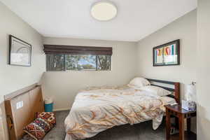 Carpeted bedroom featuring baseboards