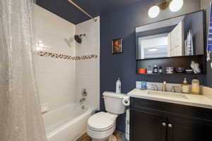 Full bathroom featuring shower / tub combo and vanity