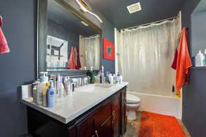 Bathroom featuring shower / bath combo and vanity