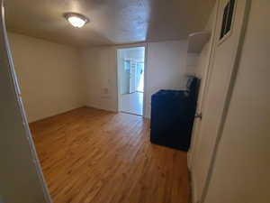 Unfurnished room with light wood-style floors and baseboards