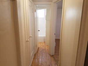 Corridor featuring light wood-style floors