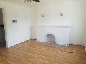 Unfurnished living room with light wood-style floors and ceiling fan