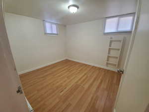 Unfurnished bedroom with light wood finished floors and baseboards