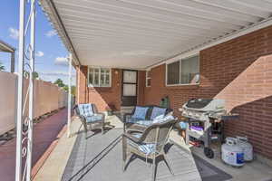 View of patio with outdoor lounge area and area for grilling