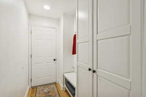 Mudroom with light wood finished floors and baseboards