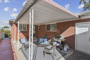 View of patio with a grill, an outdoor living space, and entry steps