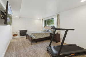 Carpeted bedroom with recessed lighting, brick wall, and a wood stove