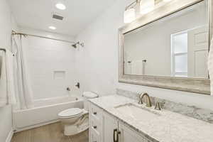 Bathroom featuring shower / tub combo, vanity, and recessed lighting