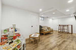 Living area with recessed lighting and light wood finished floors