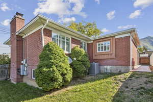 View of side of property featuring brick siding and a chimney