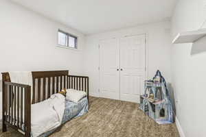 Bedroom featuring carpet flooring and a closet