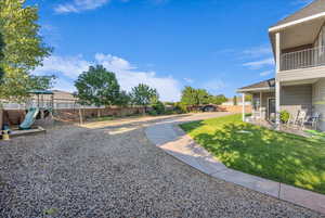 View of yard featuring a playground and a balcony